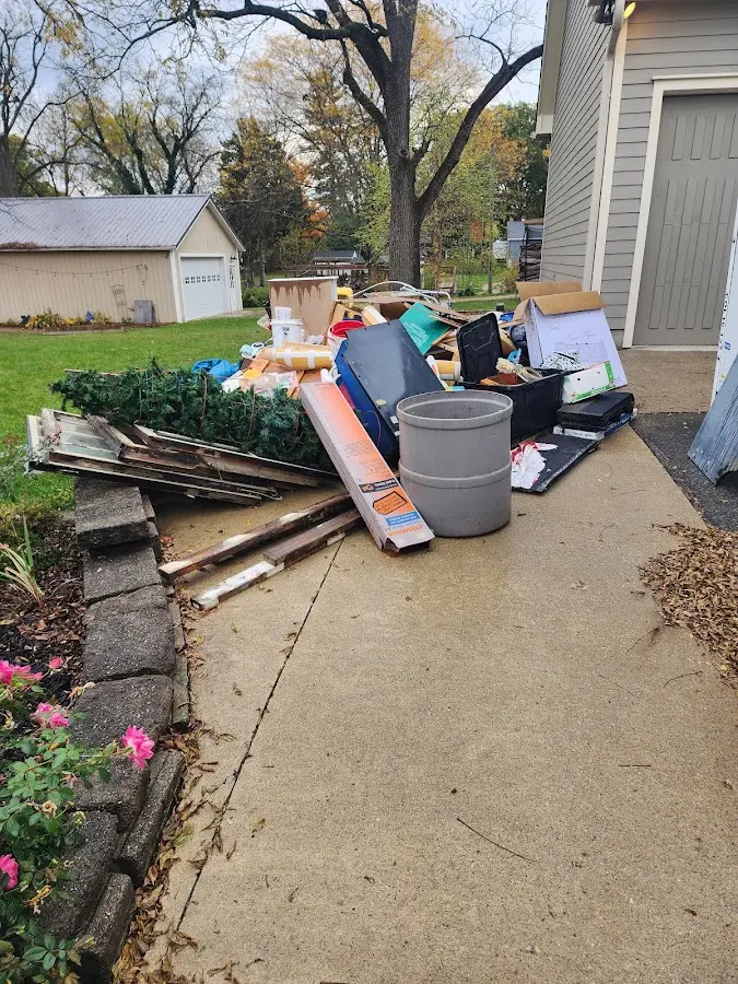 Dumpster being loaded with debris for Commercial Dumpster Rental in New Hartford